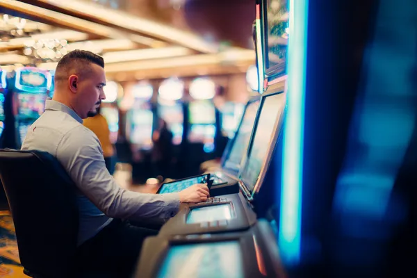 A young woman relaxing with her phone while dynamic casino elements float around her, illustrating the smooth mobile experience offered by the 77HI app.
