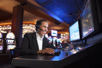 A cheerful woman in traditional clothing using her smartphone during a festive moment, showing how easily the 77HI app fits into everyday life.
