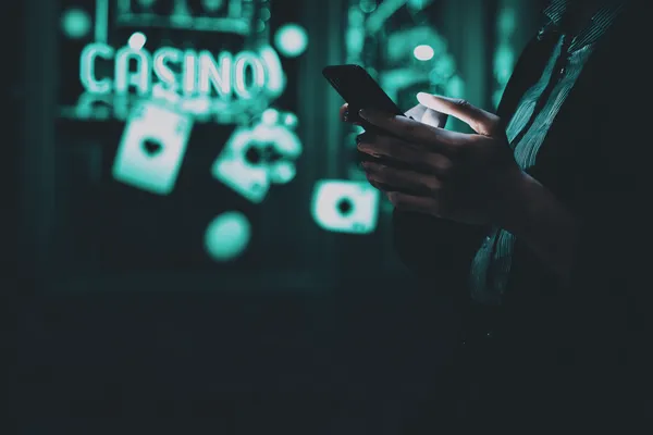 A close-up shot of golden coins falling around a spinning roulette wheel, representing immersive casino action at 77HI.